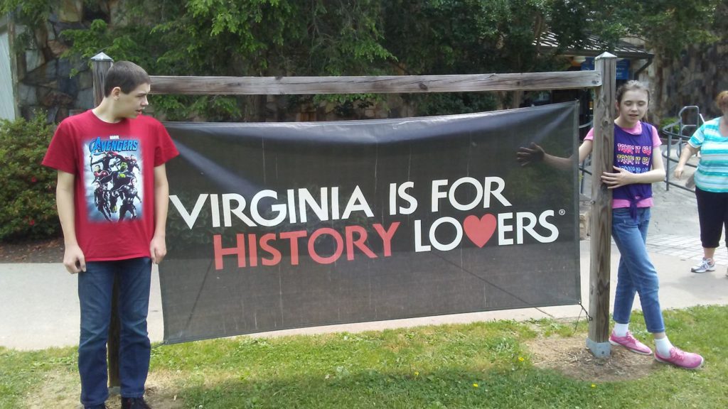 kids next to virginia sign