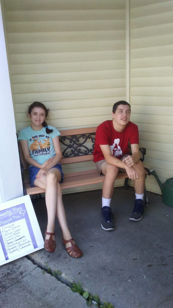 kids waiting outside a store